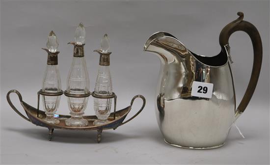 A silver plated jug and a cruet set